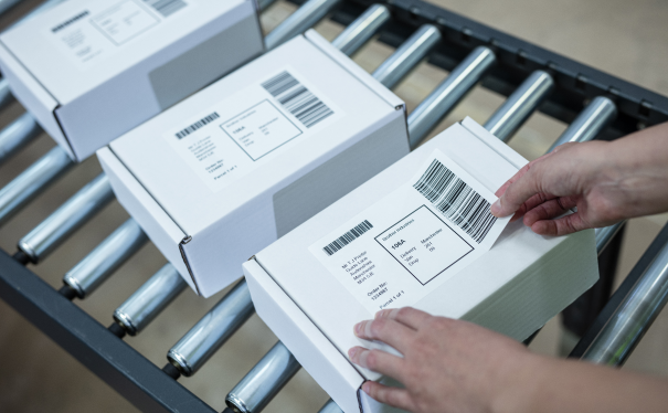 Printed labels being added to boxes